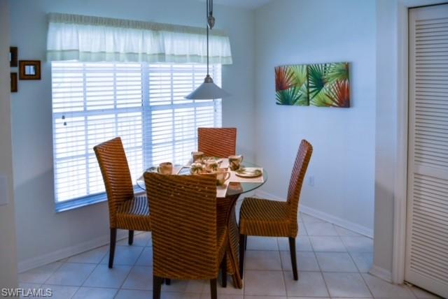 8083 Panther Trail, Unit 1504 Naples, FL 34113 - Photo 10 of 24 a view of a dining room with furniture and window