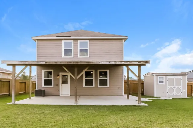 a front view of a house with a yard table and chairs