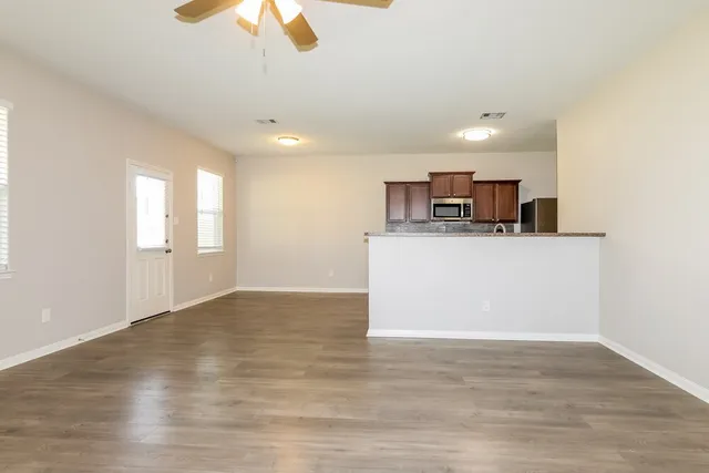a view of a kitchen with a sink cabinets and wooden floor