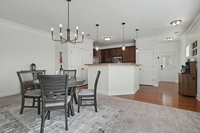 a view of a dining room with furniture and wooden floor