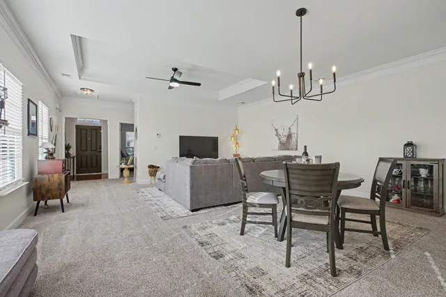 a view of a livingroom with furniture and a chandelier
