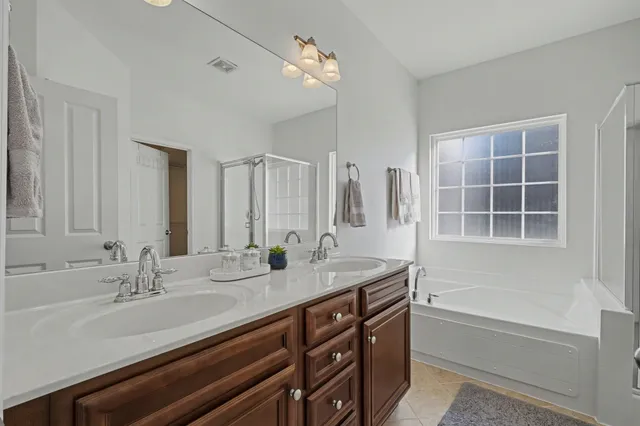 a white bath tub sitting next to a shower