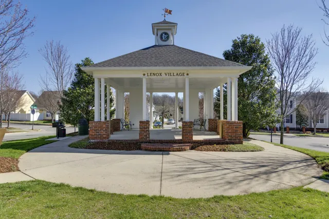 a front view of a house with a yard table and chairs