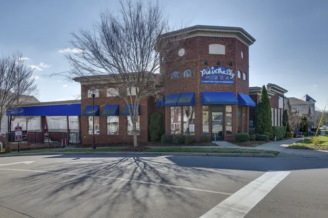 a city street lined with buildings and cars