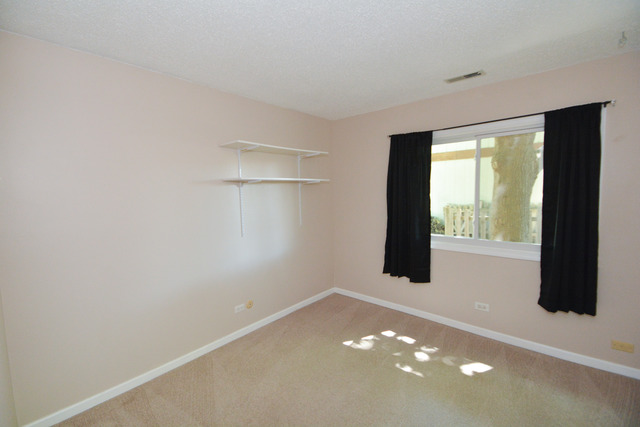 30W279 Ridgewood Court Warrenville, IL 60555 - Photo 13 of 23 a view of an empty room with a window