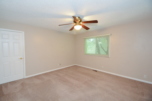 30W279 Ridgewood Court Warrenville, IL 60555 - Photo 15 of 23 an empty room with windows and fan