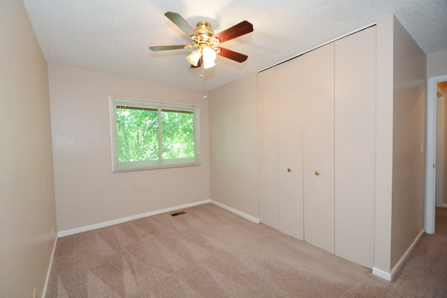 30W279 Ridgewood Court Warrenville, IL 60555 - Photo 17 of 23 an empty room with a window and a fan