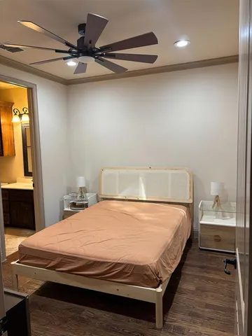 a bedroom with a bed and a ceiling fan