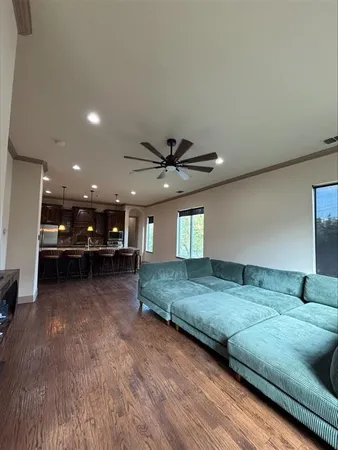 a living room with furniture and a chandelier