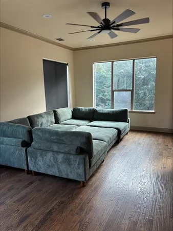 a living room with a bed furniture and a large window