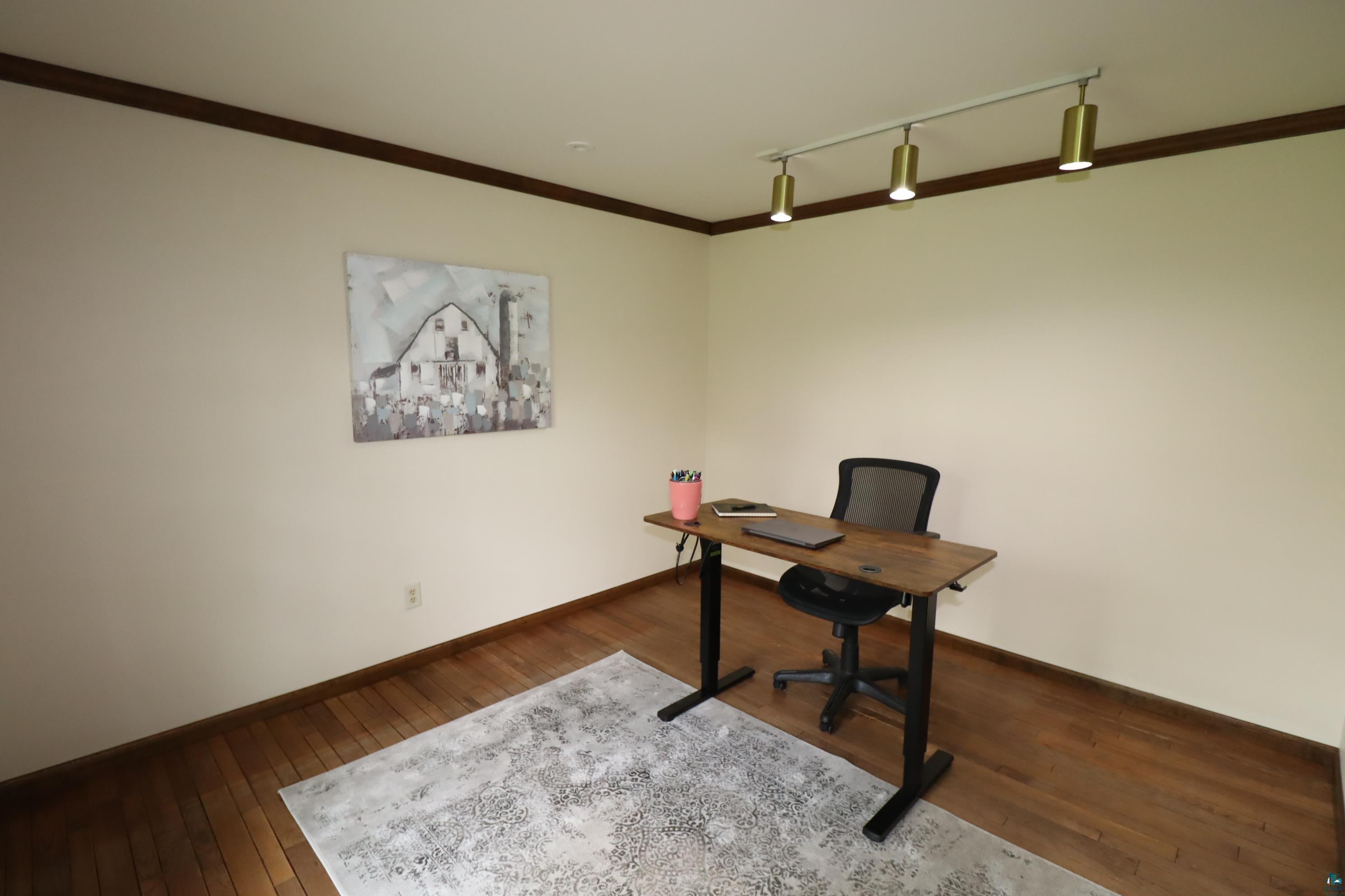 200 Maple Ridge Ashland, WI 54806 - Photo 19 of 40 Home office featuring crown molding, wood flooring, and track lighting