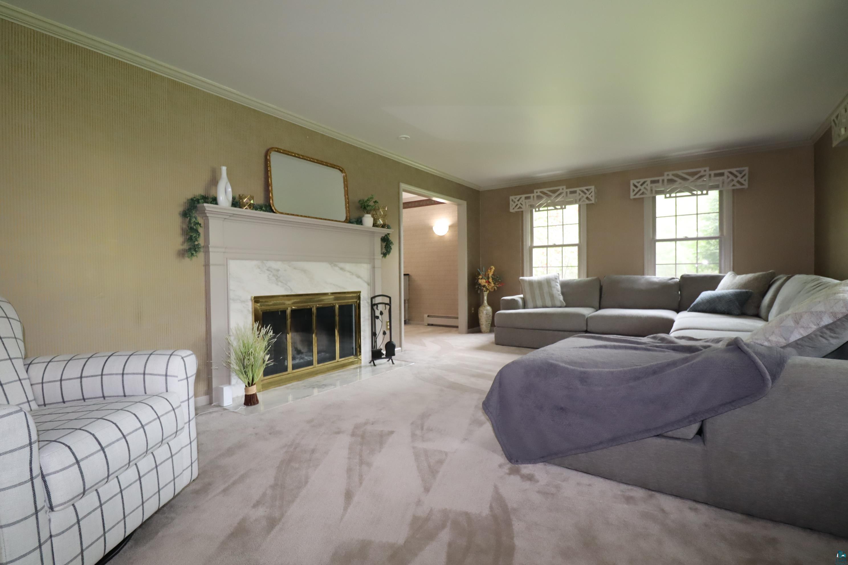 200 Maple Ridge Ashland, WI 54806 - Photo 2 of 40 Formal living room featuring a premium fireplace, and ornamental molding.