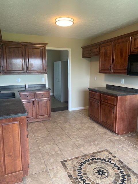 429 Fowler Ford Road Portland, TN 37148 - Photo 4 of 12 a kitchen with stainless steel appliances granite countertop a sink stove and cabinets