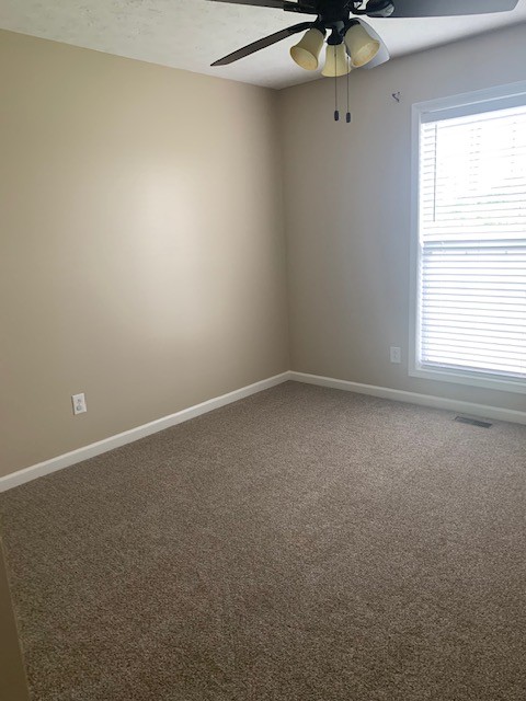 429 Fowler Ford Road Portland, TN 37148 - Photo 9 of 12 an empty room with a window and a fan
