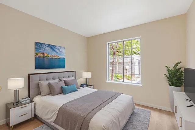 a bedroom with bed and wooden floor