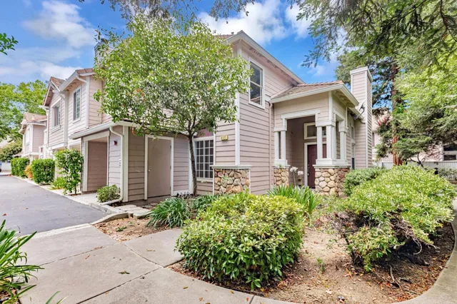 an empty room with wooden floor cabinet and windows