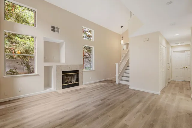 a kitchen with white cabinets and appliances