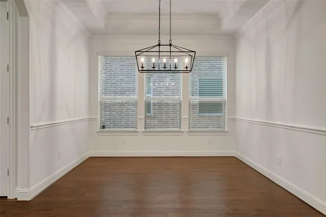 a view of wooden floor and windows in a room