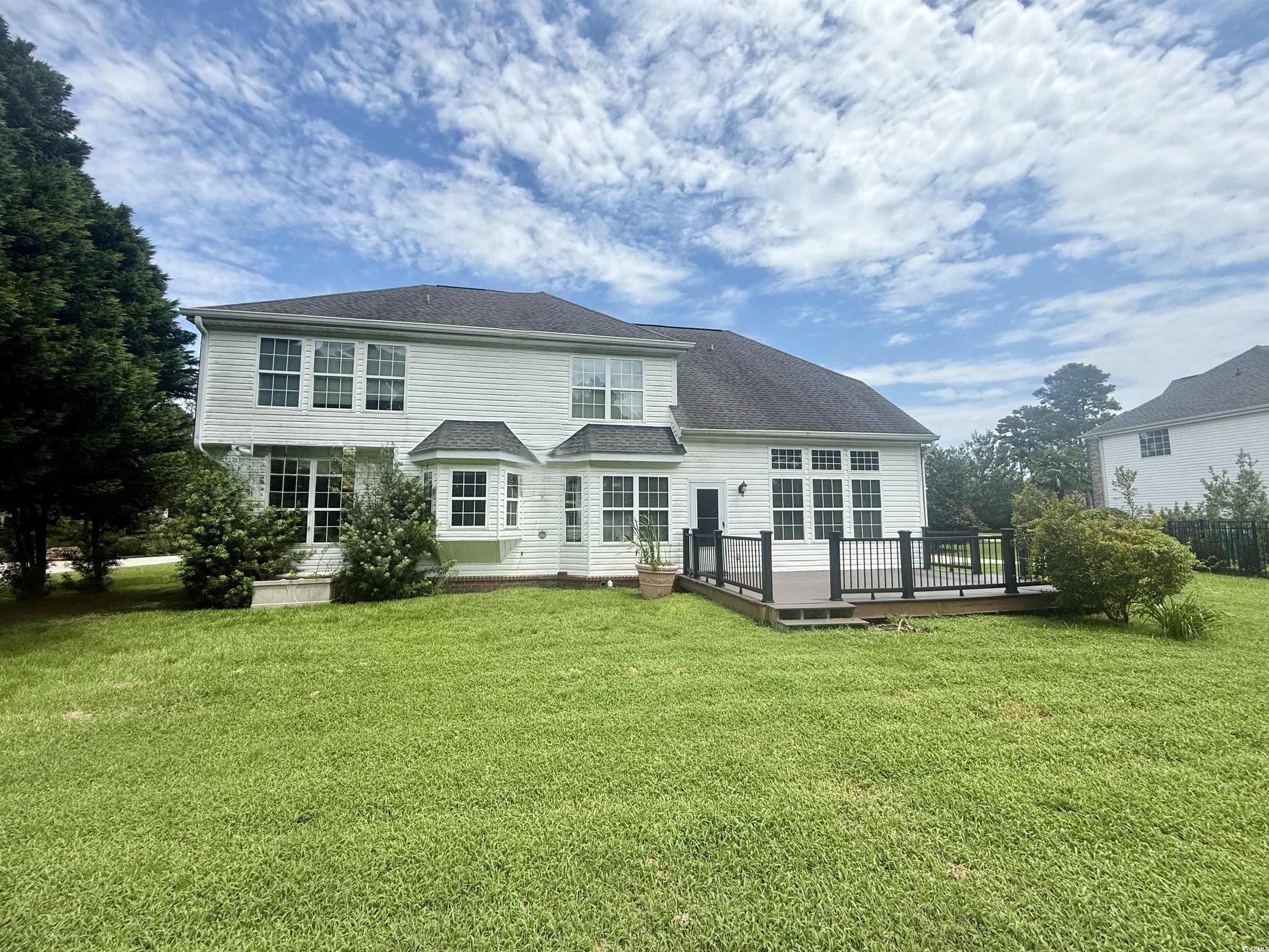 3848 Waterford Drive Myrtle Beach, SC 29577 - Photo 12 of 12 Back of property featuring a deck, a lawn, and a shingled roof