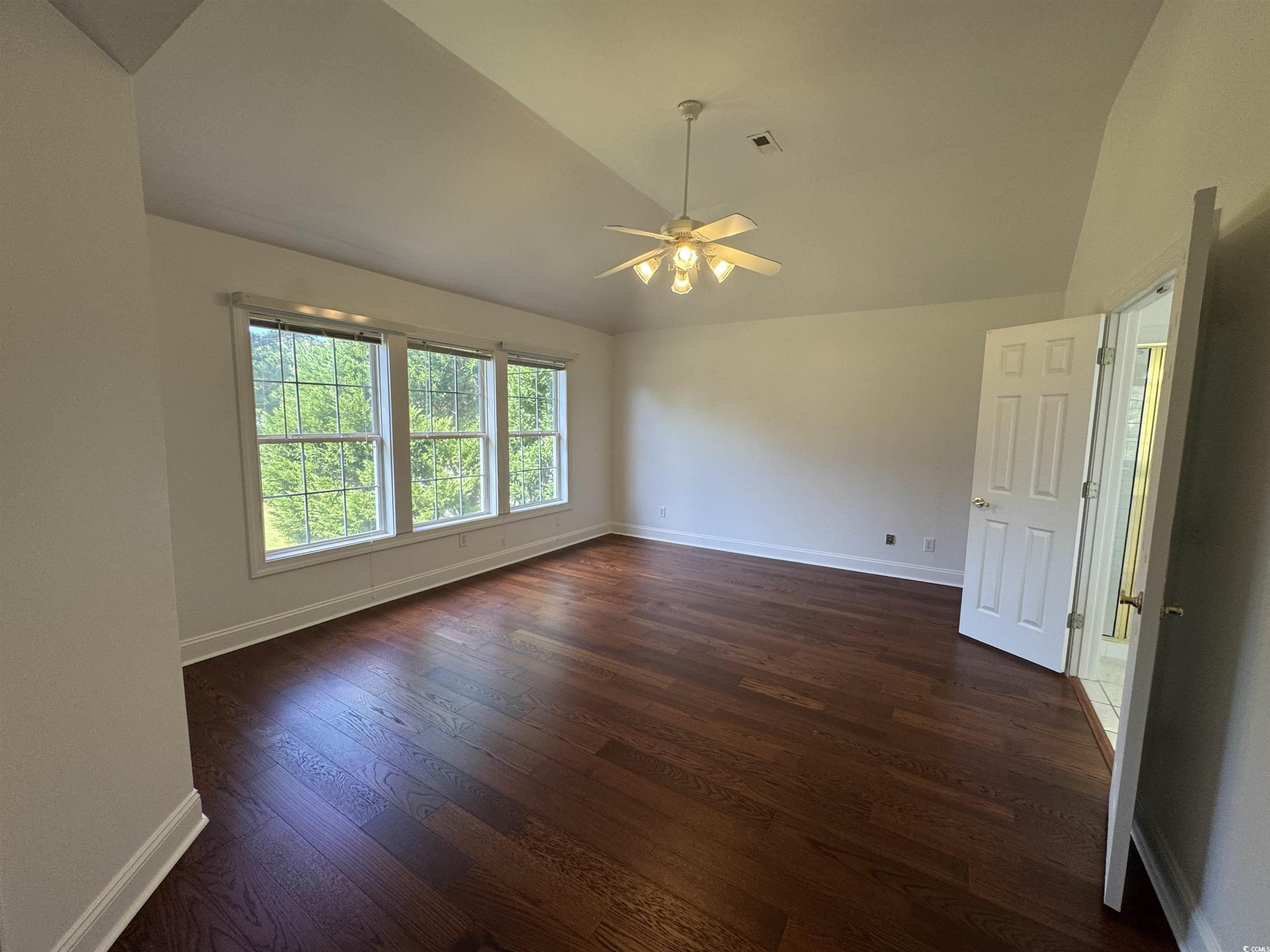 3848 Waterford Drive Myrtle Beach, SC 29577 - Photo 6 of 12 Spare room featuring vaulted ceiling, dark wood-style flooring, and a ceiling fan