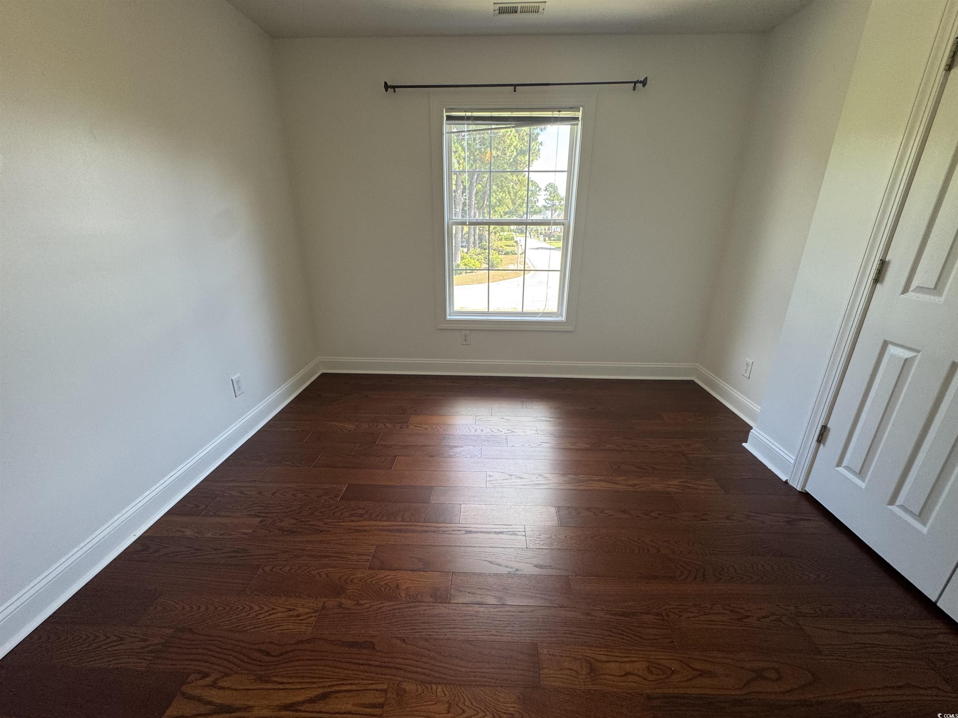 3848 Waterford Drive Myrtle Beach, SC 29577 - Photo 8 of 12 Empty room with baseboards and dark wood-style floors