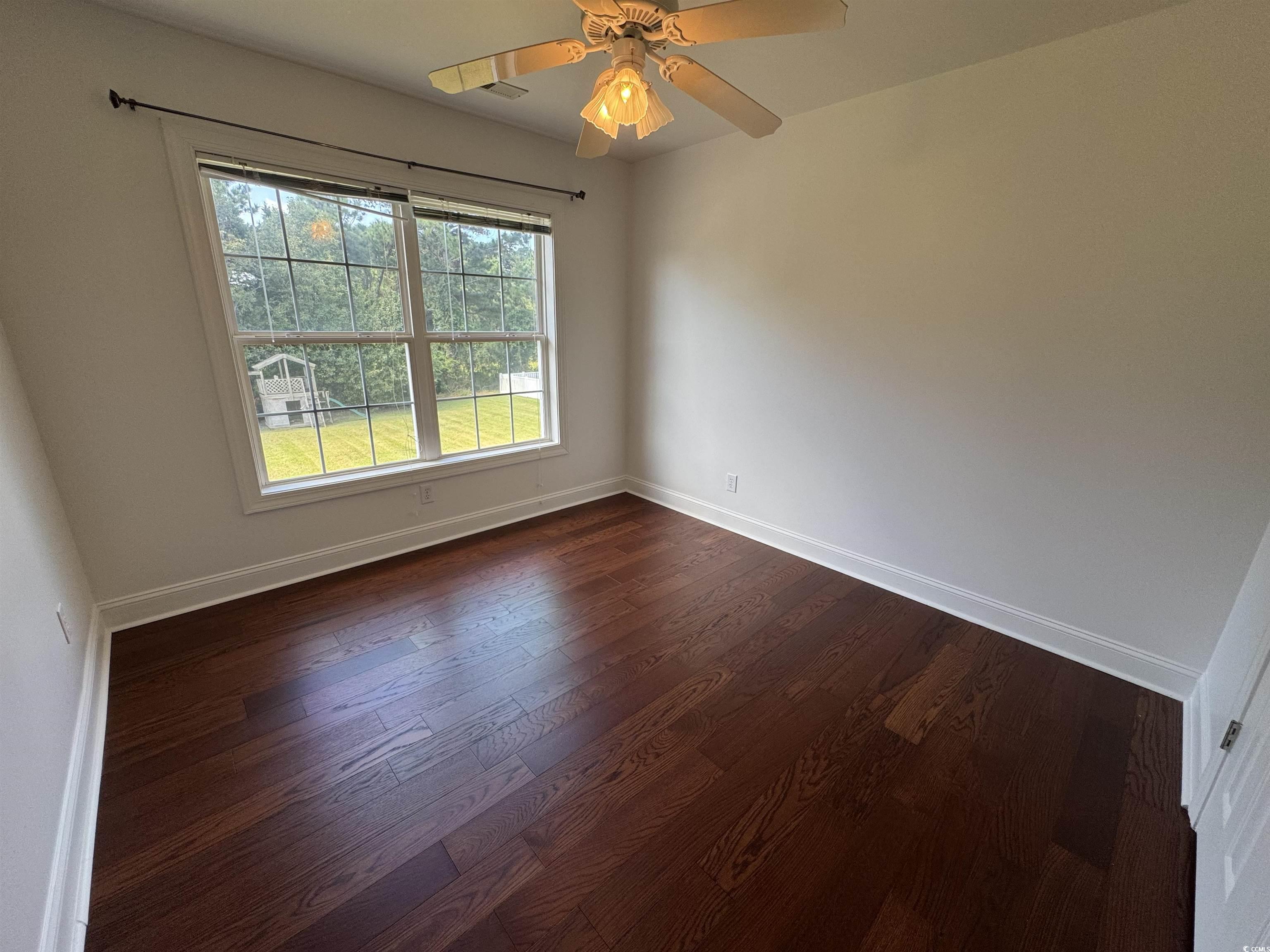 3848 Waterford Drive Myrtle Beach, SC 29577 - Photo 9 of 12 Empty room featuring dark wood-type flooring and ceiling fan