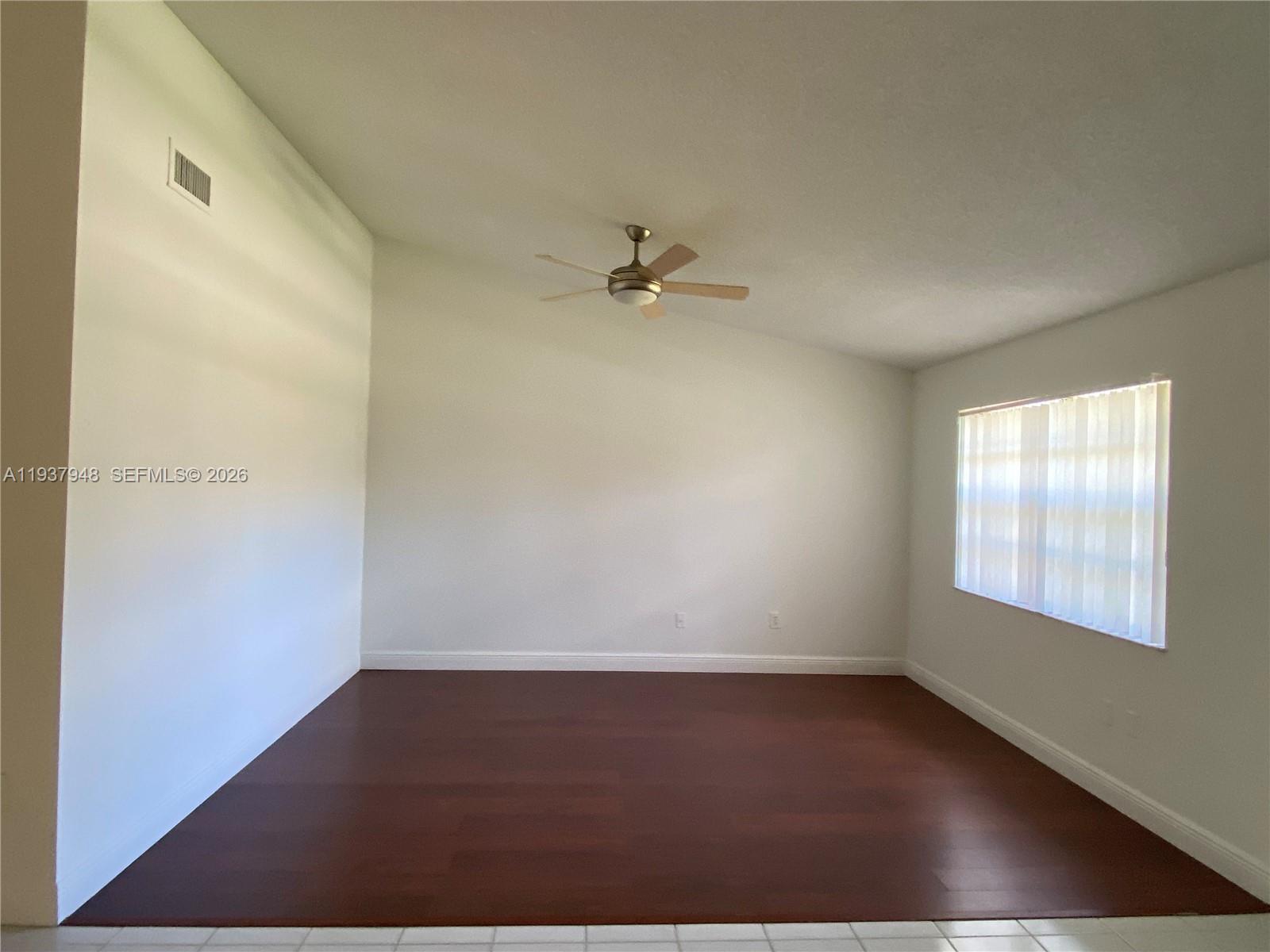 1297 Southwest 151st Avenue Sunrise, FL 33326 - Photo 2 of 12 an empty room with wooden floor and windows