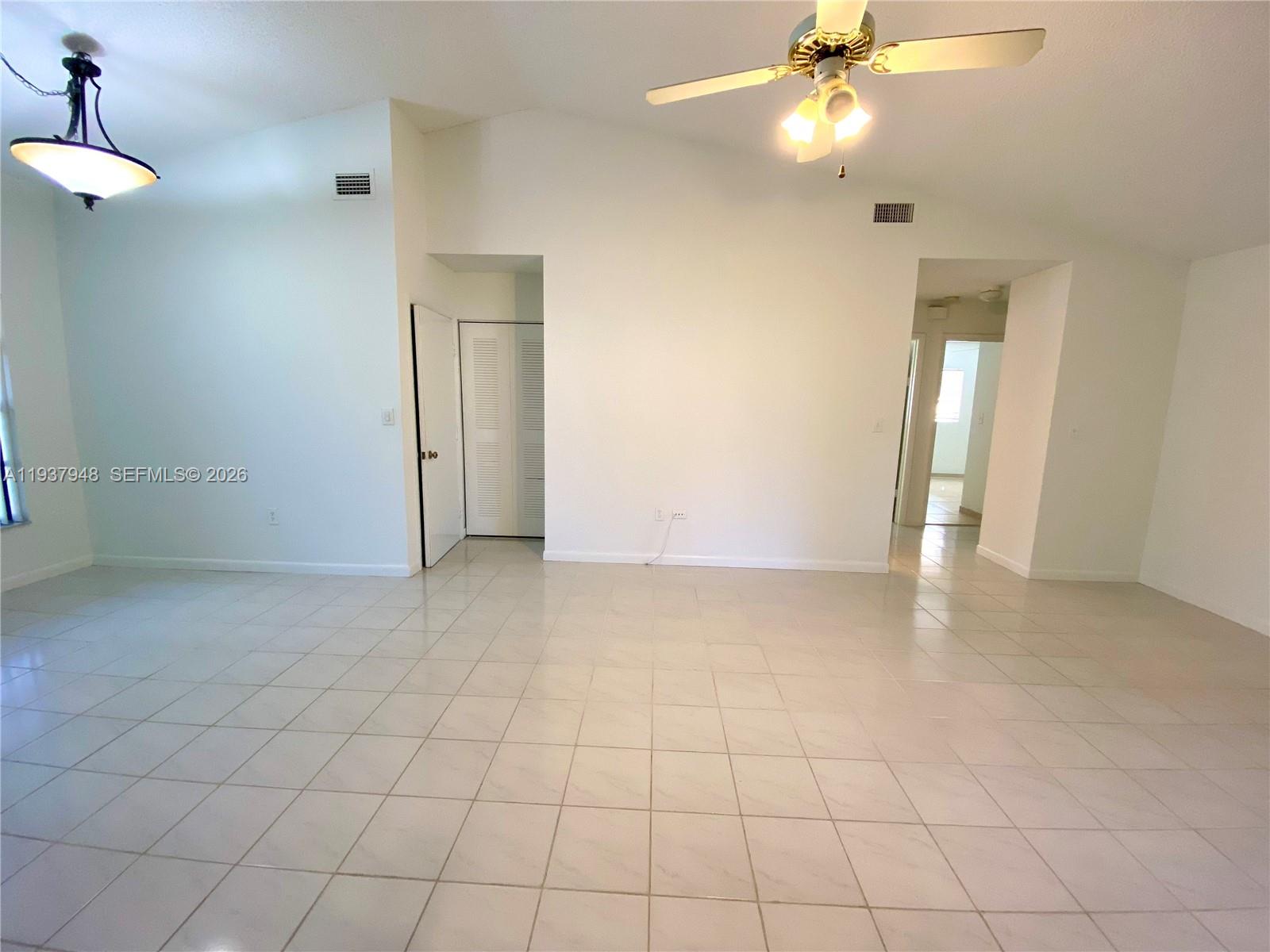 1297 Southwest 151st Avenue Sunrise, FL 33326 - Photo 3 of 12 a view of an empty room with a chandelier fan