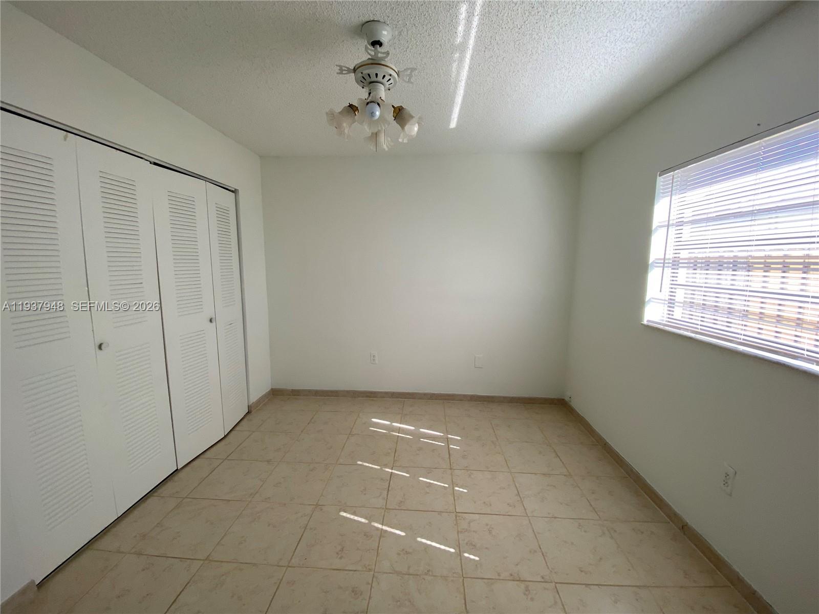 1297 Southwest 151st Avenue Sunrise, FL 33326 - Photo 4 of 12 a view of an empty room with a window