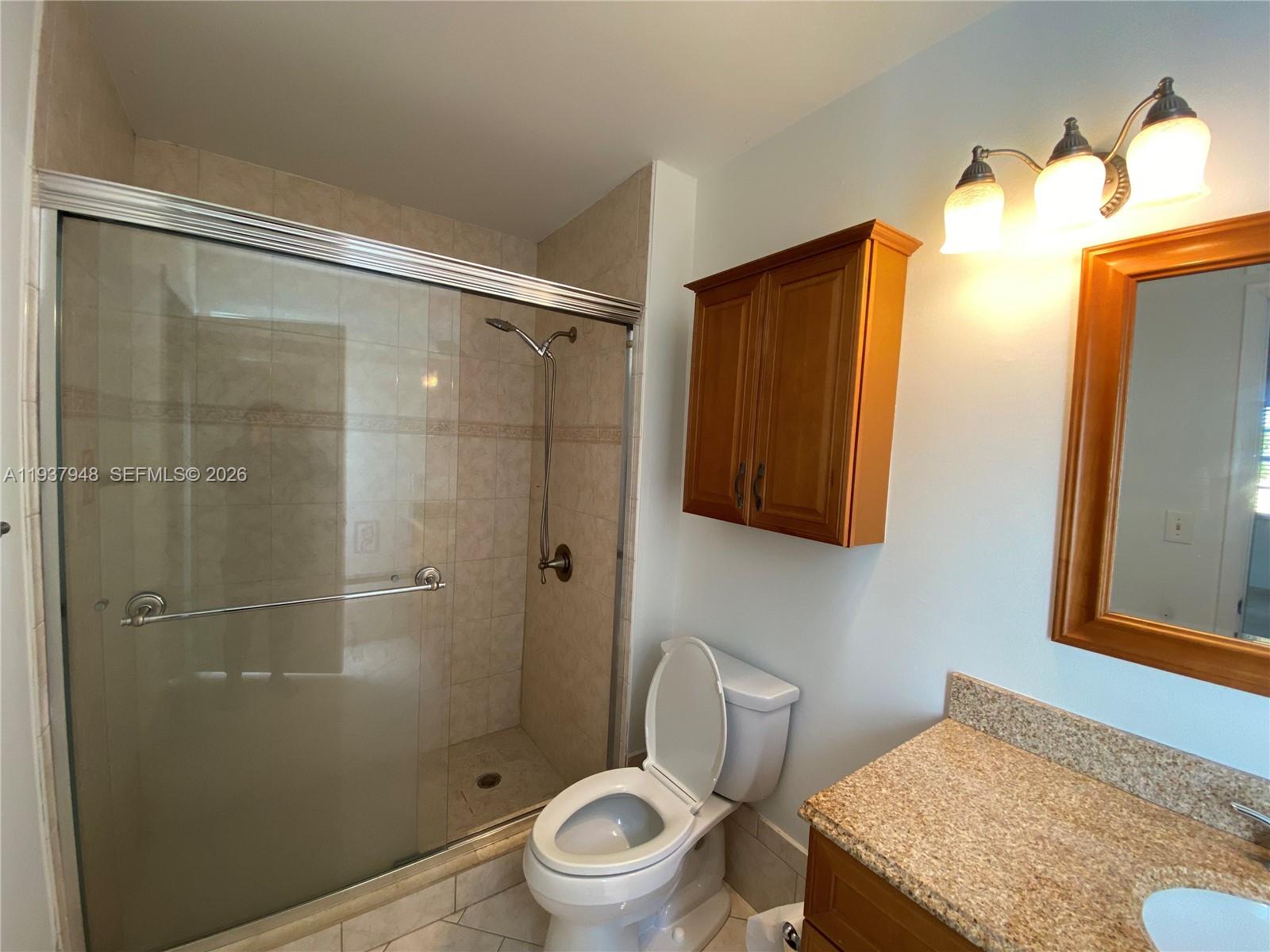 1297 Southwest 151st Avenue Sunrise, FL 33326 - Photo 7 of 12 a bathroom with a toilet and a shower