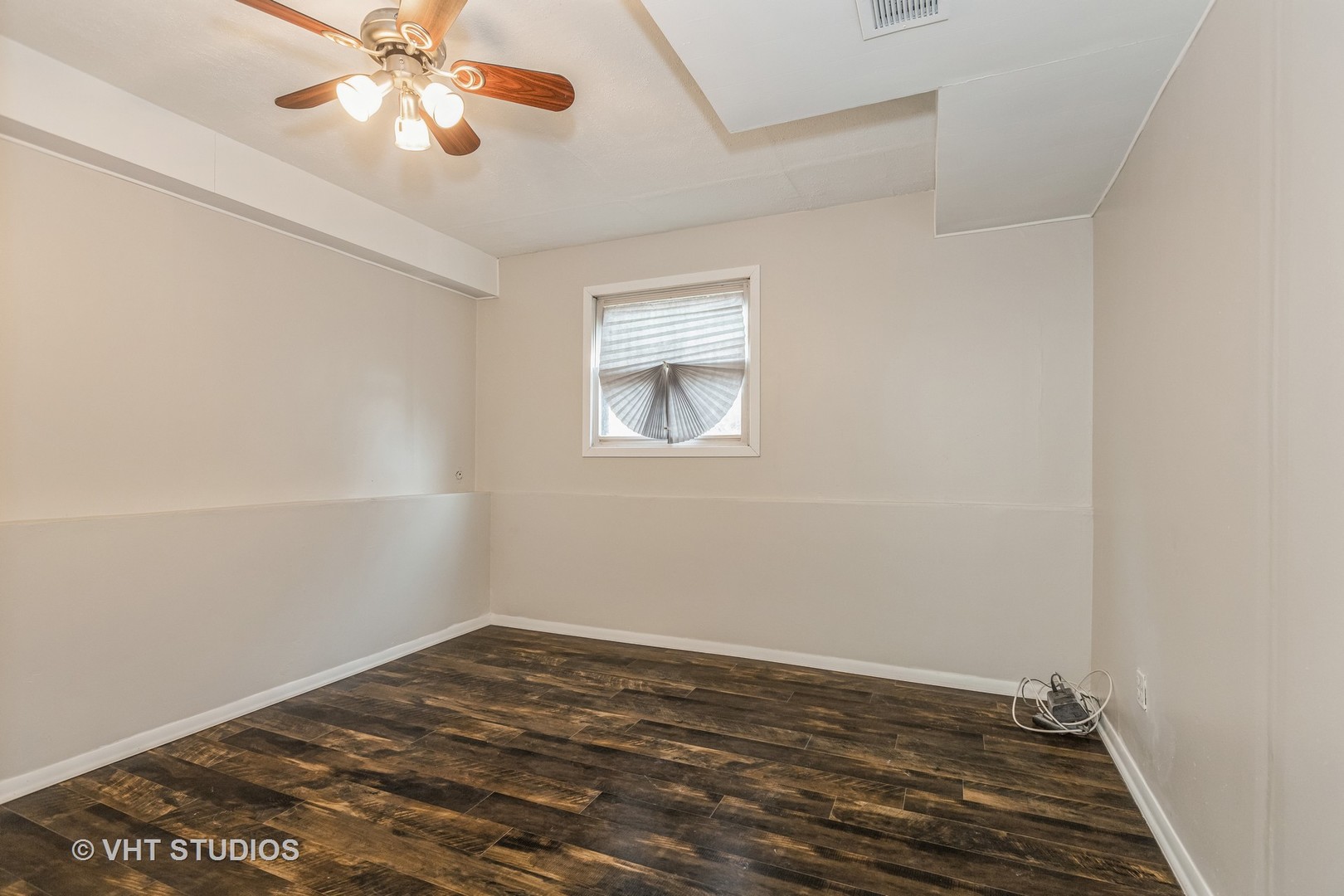 623 Quail Run Road Matteson, IL 60443 - Photo 11 of 16 an empty room with a window and a chandelier fan