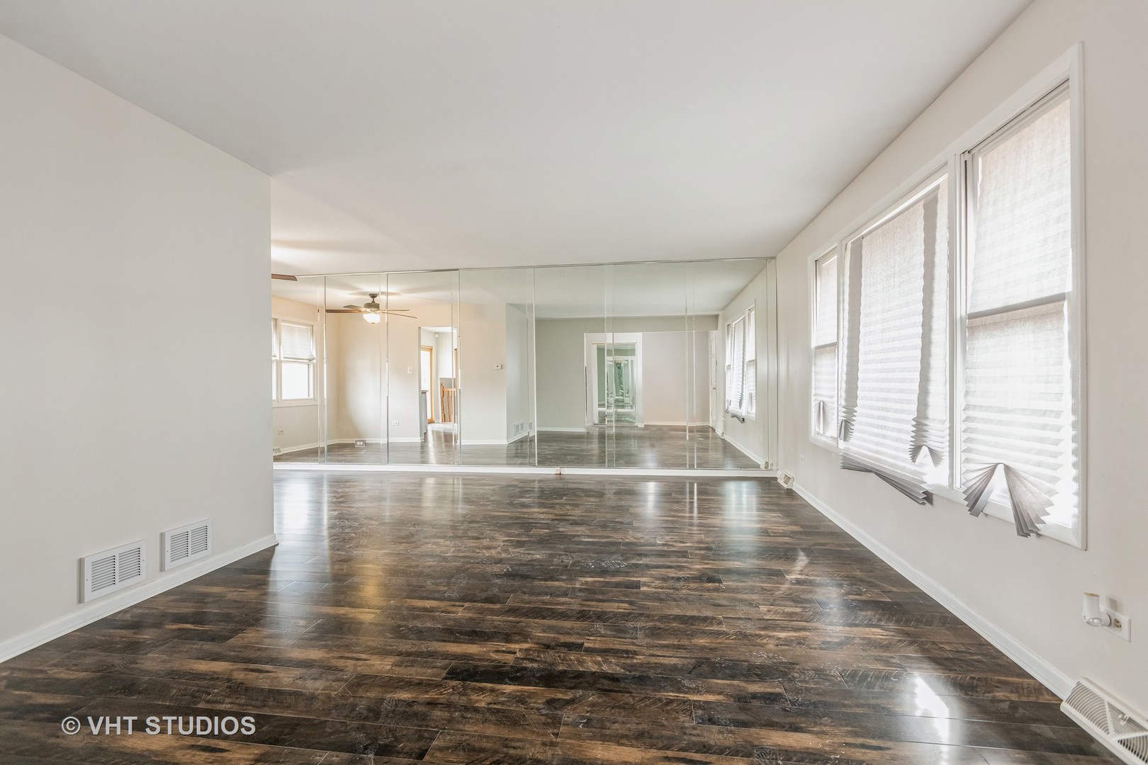 623 Quail Run Road Matteson, IL 60443 - Photo 2 of 16 a view of an empty room with wooden floor and a window