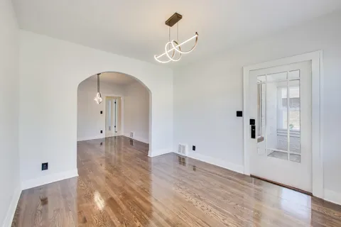a view of a room with wooden floor and windows