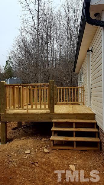 37 Eli Court Roxboro, NC 27573 - Photo 12 of 13 a view of backyard with large trees and wooden fence