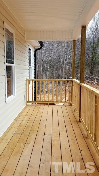 37 Eli Court Roxboro, NC 27573 - Photo 3 of 13 a view of a balcony with wooden floor and bench