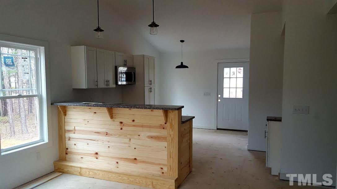 37 Eli Court Roxboro, NC 27573 - Photo 5 of 13 an empty room with windows and cabinet