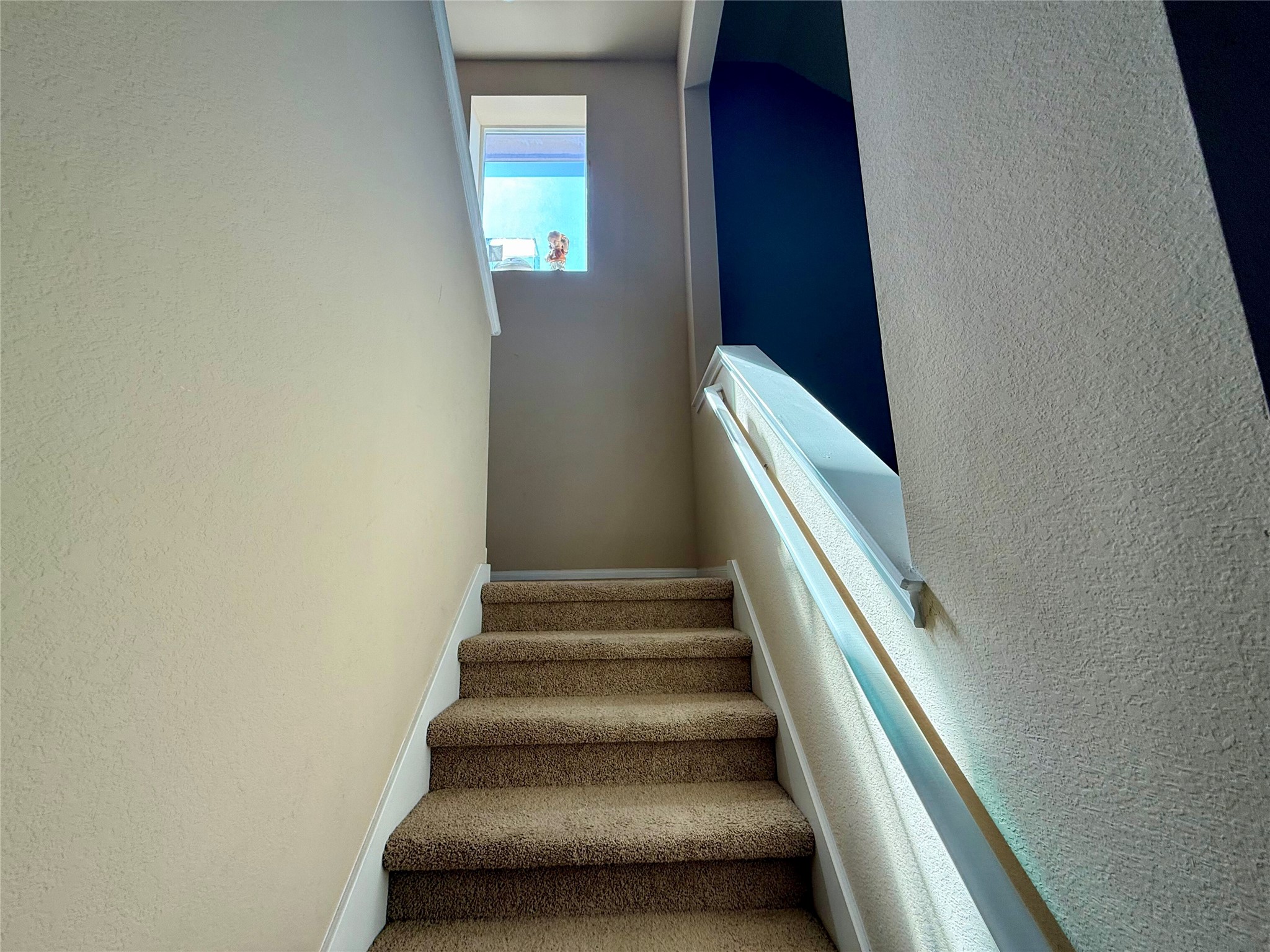 11700 Andesite Road Manor, TX 78653 - Photo 15 of 32 Ascend to comfort with soft carpeting underfoot, illuminated by a high-set window.