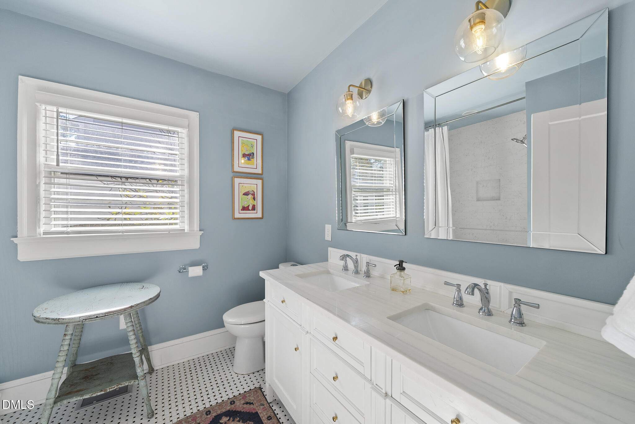 1108 Brooks Avenue Raleigh, NC 27607 - Photo 15 of 35 a bathroom with a granite countertop sink a toilet a mirror and a window