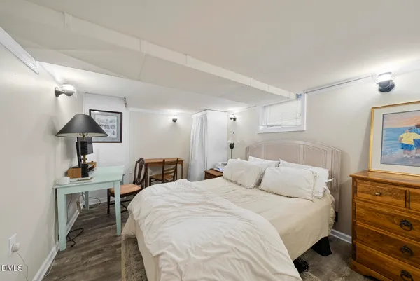 a bedroom with a bed and a desk