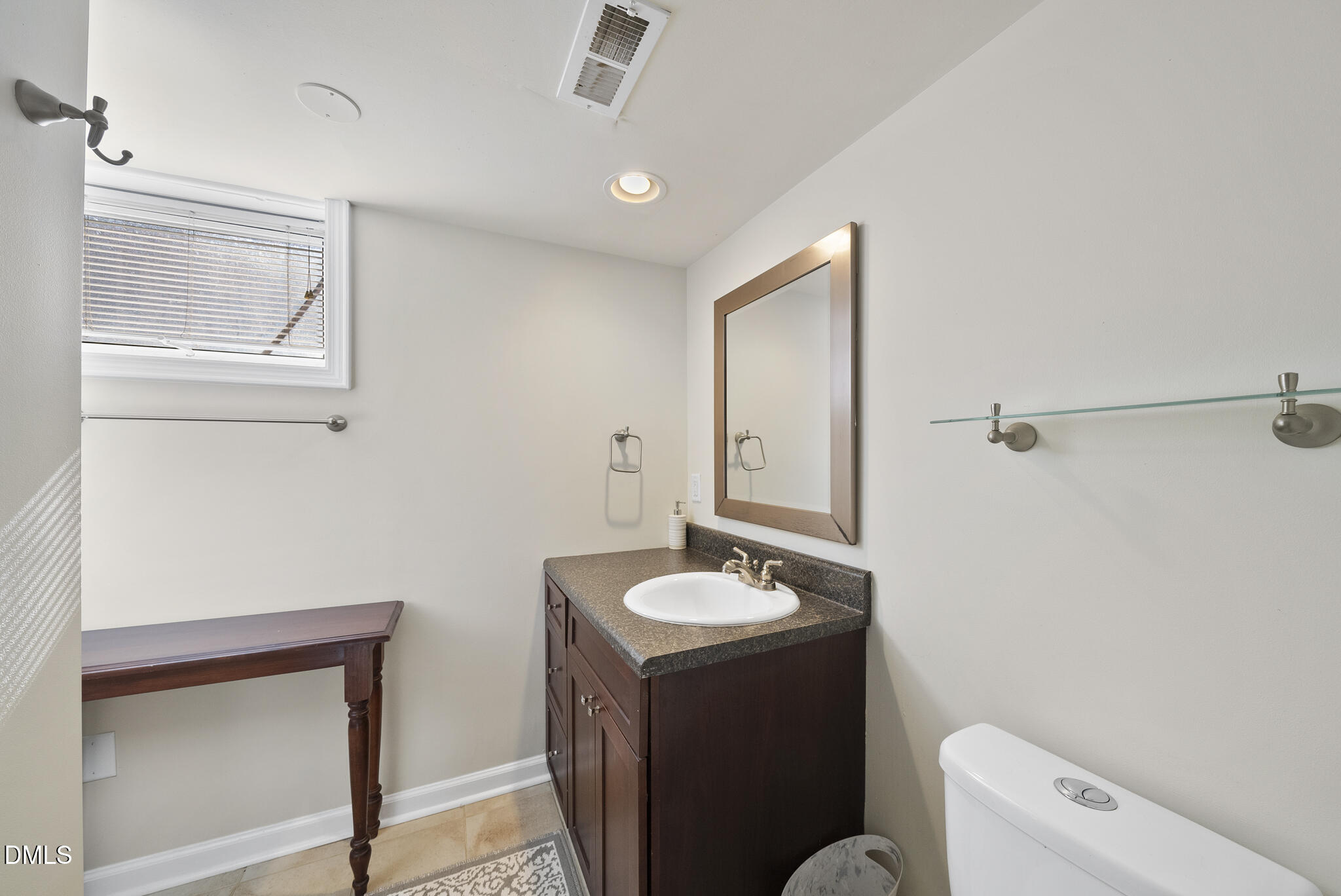 1108 Brooks Avenue Raleigh, NC 27607 - Photo 22 of 35 a bathroom with a sink a toilet and a mirror