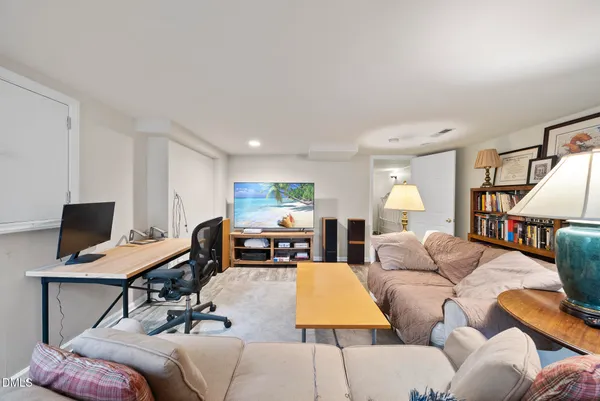 a living room with fireplace furniture and a wooden floor
