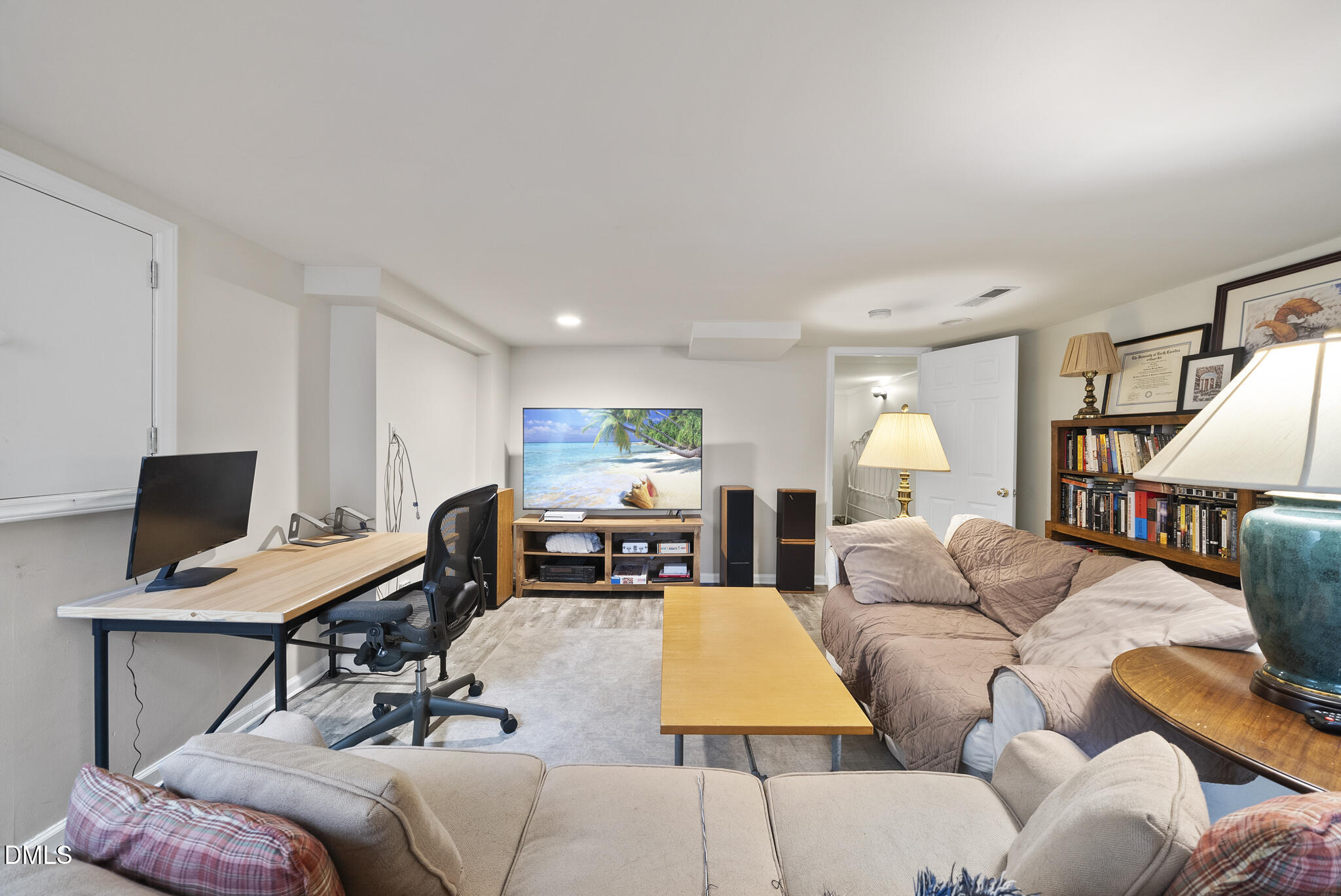 1108 Brooks Avenue Raleigh, NC 27607 - Photo 24 of 35 a living room with furniture a flat screen tv and a large window