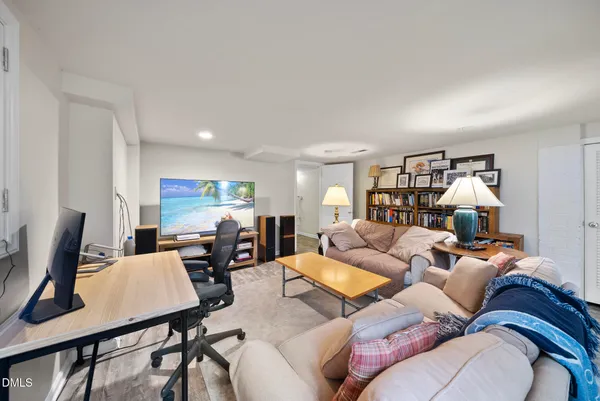 a living room with furniture two couch and a window