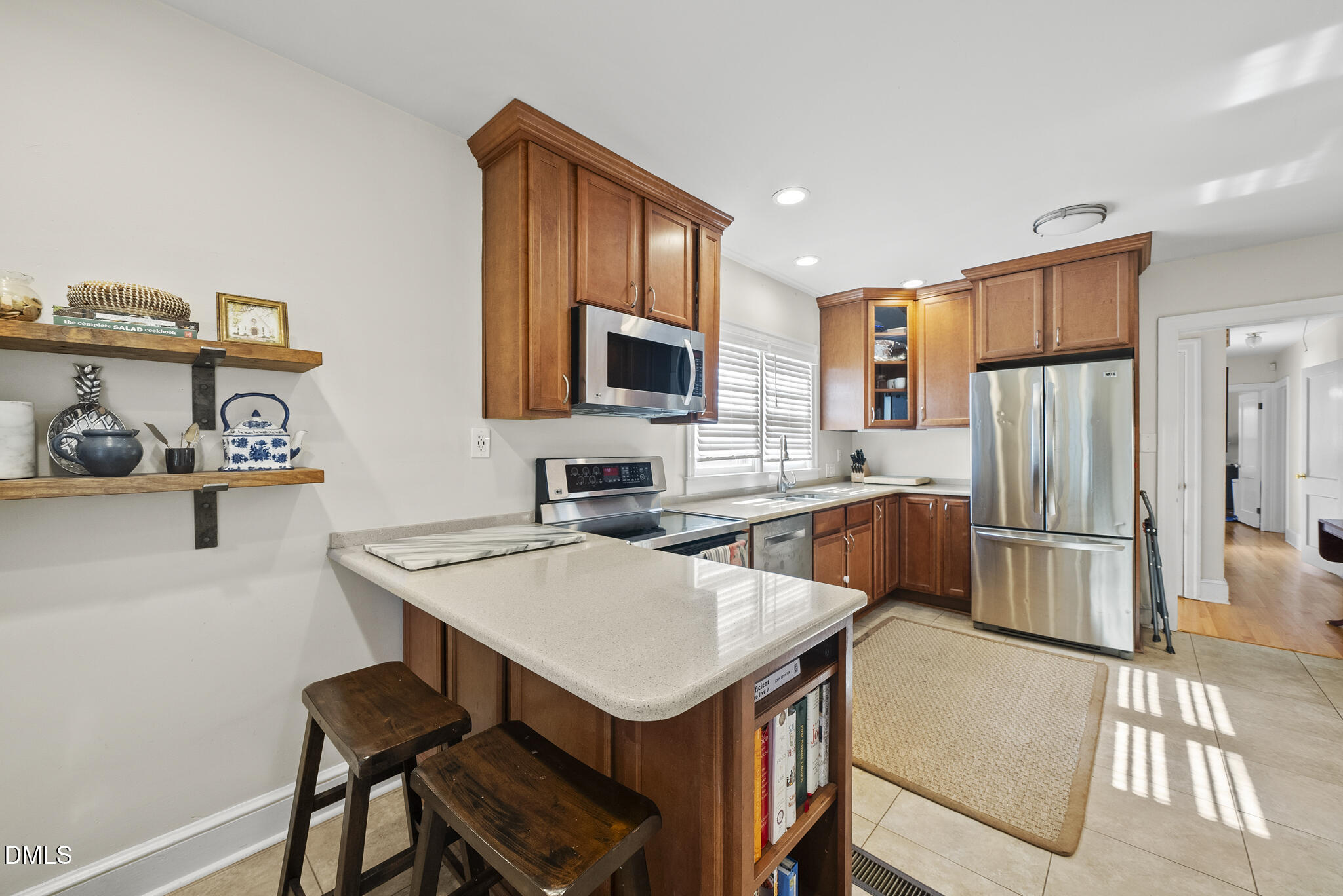 1108 Brooks Avenue Raleigh, NC 27607 - Photo 9 of 35 a kitchen with a refrigerator a stove a sink dishwasher with a dining table and chairs