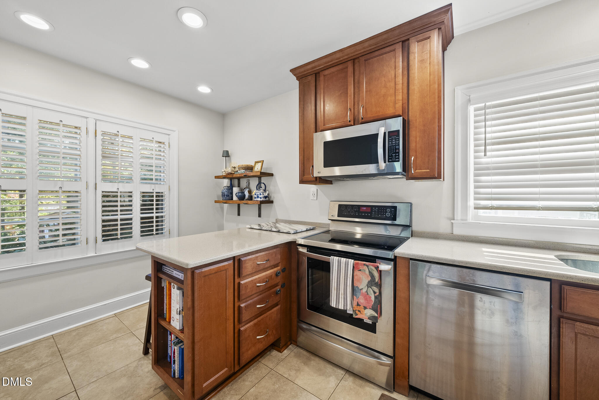 1108 Brooks Avenue Raleigh, NC 27607 - Photo 10 of 35 a kitchen with stainless steel appliances granite countertop a stove a sink and a microwave