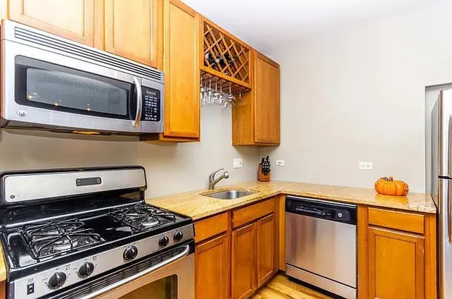 a kitchen with stainless steel appliances a stove and a microwave