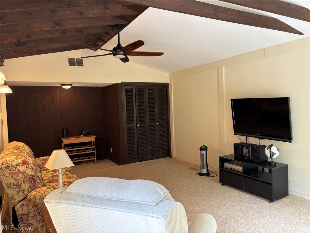 5595 Meister Road Mentor, OH 44060 - Photo 11 of 26 Living room with light colored carpet, ceiling fan, and vaulted ceiling with beams