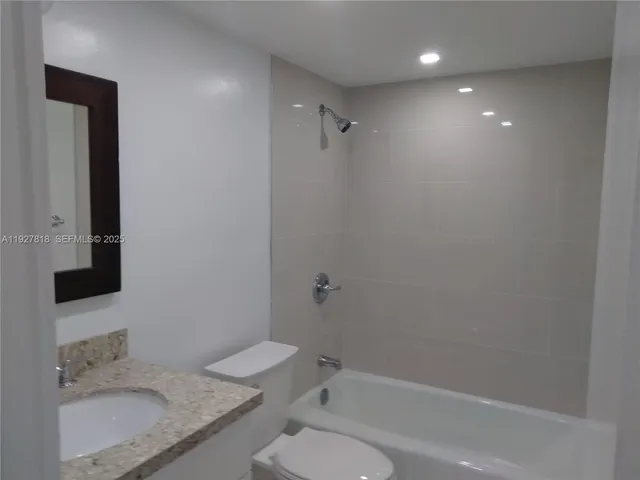 a bath room with a toilet and a shower