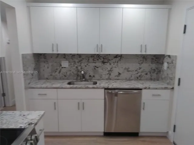 a view of a kitchen from the hallway