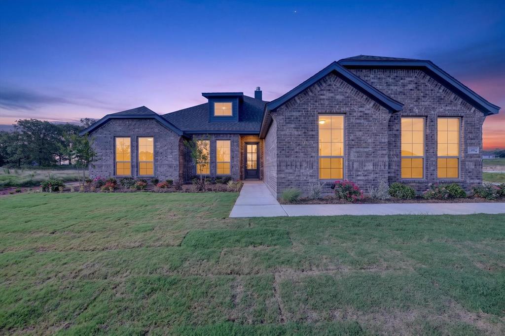 416 McAlpine Drive Springtown, TX 76082 - Photo 1 of 40 Brick exterior residence featuring a dark shingle roof and a central dormer